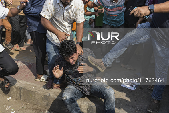 Students from anti-discrimination movements and Bangladesh Nationalist Party activists attack an Awami League supporter in Dhaka, Bangladesh...