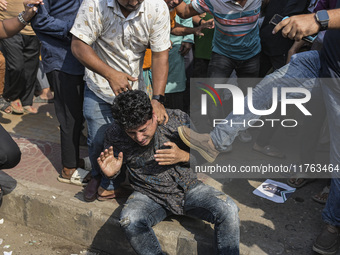 Students from anti-discrimination movements and Bangladesh Nationalist Party activists attack an Awami League supporter in Dhaka, Bangladesh...