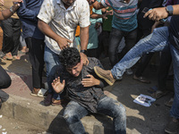 Students from anti-discrimination movements and Bangladesh Nationalist Party activists attack an Awami League supporter in Dhaka, Bangladesh...