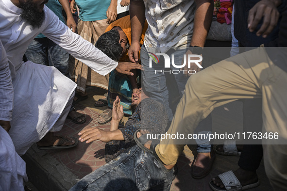 Students from anti-discrimination movements and Bangladesh Nationalist Party activists attack an Awami League supporter in Dhaka, Bangladesh...