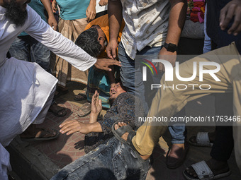 Students from anti-discrimination movements and Bangladesh Nationalist Party activists attack an Awami League supporter in Dhaka, Bangladesh...