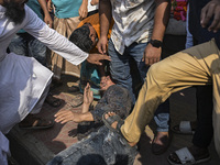 Students from anti-discrimination movements and Bangladesh Nationalist Party activists attack an Awami League supporter in Dhaka, Bangladesh...