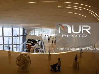 Visitors watch exhibitions in HeydarAliyev Centre in Baku, the capital of Azerbaijan on November 10, 2024. (