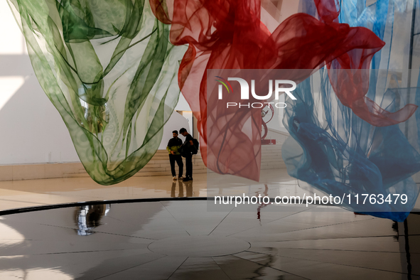 Visitors watch exhibitions in HeydarAliyev Centre in Baku, the capital of Azerbaijan on November 10, 2024. 