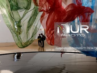 Visitors watch exhibitions in HeydarAliyev Centre in Baku, the capital of Azerbaijan on November 10, 2024. (