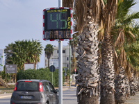 A solar-powered speed indicator installed along a palm-lined road aims to promote safe driving by monitoring and displaying vehicle speeds....