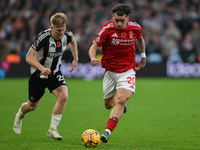 Jota Silva of Nottingham Forest is under pressure from Lewis Hall of Newcastle United during the Premier League match between Nottingham For...