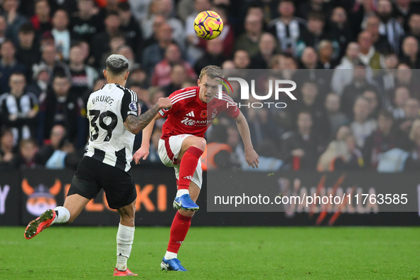 James Ward-Prowse of Nottingham Forest plays the ball forward under pressure from Bruno Guimaraes of Newcastle United during the Premier Lea...