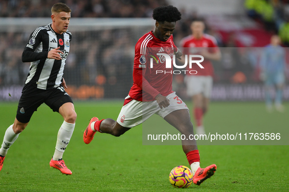 Ola Aina of Nottingham Forest is under pressure from Harvey Barnes of Newcastle United during the Premier League match between Nottingham Fo...