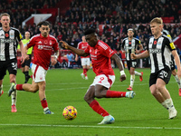 Taiwo Awoniyi of Nottingham Forest is under pressure from Lewis Hall of Newcastle United during the Premier League match between Nottingham...