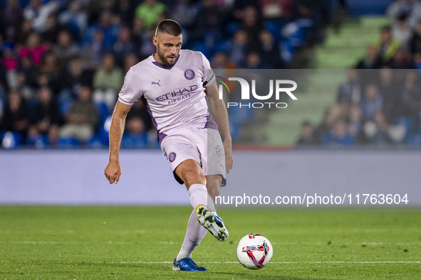 David Lopez of Girona FC is in action with the ball during the La Liga EA Sports 2024/25 football match between Getafe CF and Girona FC at E...