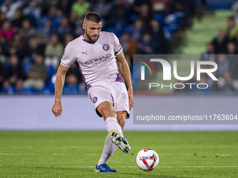 David Lopez of Girona FC is in action with the ball during the La Liga EA Sports 2024/25 football match between Getafe CF and Girona FC at E...