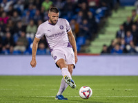 David Lopez of Girona FC is in action with the ball during the La Liga EA Sports 2024/25 football match between Getafe CF and Girona FC at E...