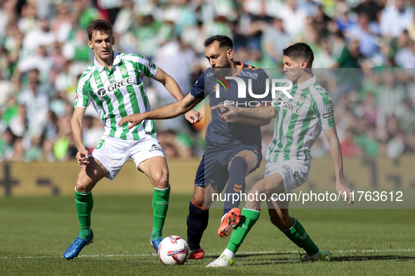 In Seville, Spain, on November 10, 2024, Sergi Altimira of Real Betis, Diego Llorente of Real Betis, and Borja Iglesias of RC Celta de Vigo...