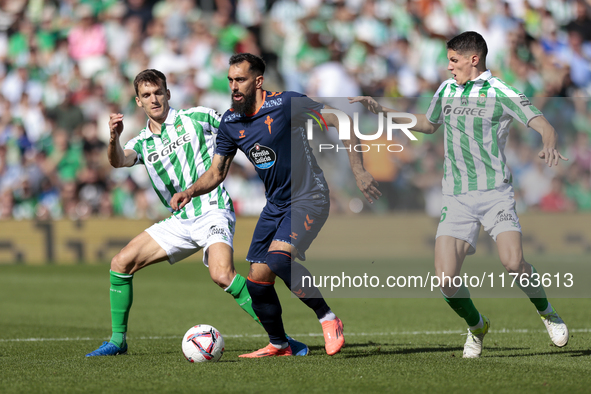 Borja Iglesias of RC Celta de Vigo competes for the ball with Diego Llorente of Real Betis during the La Liga EA Sport match between Real Be...