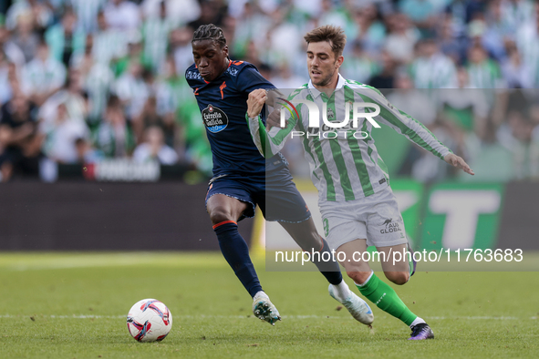 Iker Losada of Real Betis competes for the ball with Ilaix Moriba of RC Celta de Vigo during the La Liga EA Sport match between Real Betis a...