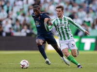 Iker Losada of Real Betis competes for the ball with Ilaix Moriba of RC Celta de Vigo during the La Liga EA Sport match between Real Betis a...