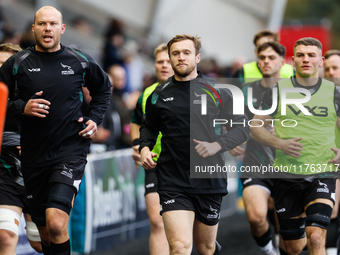 Brett Connon (center of picture) of Newcastle Falcons leads his players out for the warm-up for the Premiership Cup Pool A match between New...