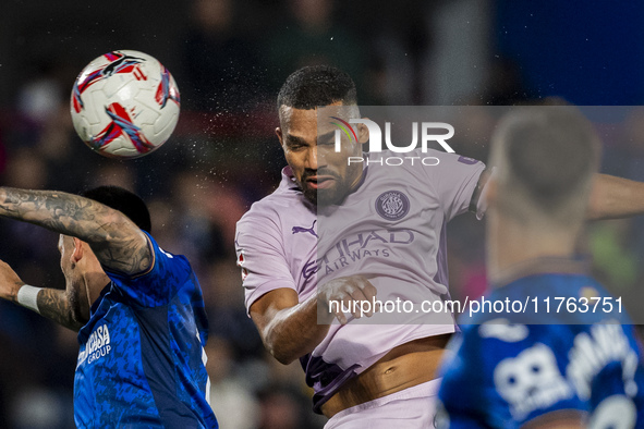 Yangel Herrera of Girona FC (C) heads the ball to score a goal during the La Liga EA Sports 2024/25 football match between Getafe CF and Gir...