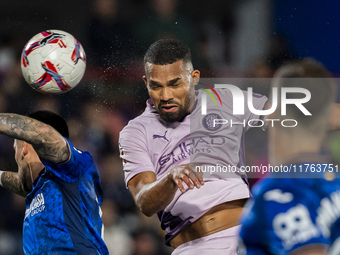 Yangel Herrera of Girona FC (C) heads the ball to score a goal during the La Liga EA Sports 2024/25 football match between Getafe CF and Gir...