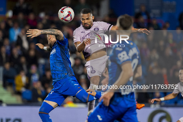 Yangel Herrera of Girona FC (C) heads the ball to score a goal during the La Liga EA Sports 2024/25 football match between Getafe CF and Gir...