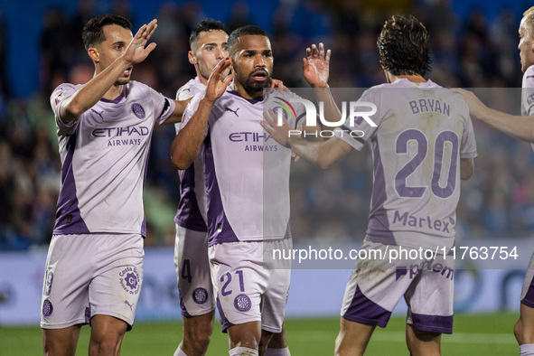 Yangel Herrera of Girona FC celebrates his goal with his teammates Bojan Miovski (left) and Bryan Gil (right) during the La Liga EA Sports 2...