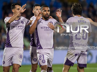 Yangel Herrera of Girona FC celebrates his goal with his teammates Bojan Miovski (left) and Bryan Gil (right) during the La Liga EA Sports 2...