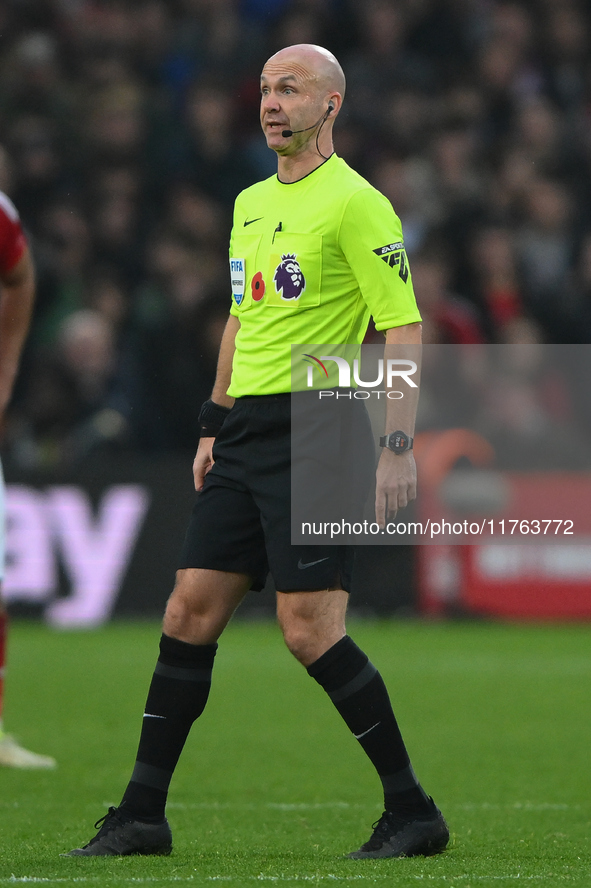 Referee Anthony Taylor officiates the Premier League match between Nottingham Forest and Newcastle United at the City Ground in Nottingham,...