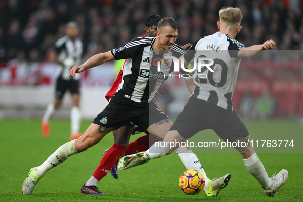 Dan Burn of Newcastle United is in action during the Premier League match between Nottingham Forest and Newcastle United at the City Ground...