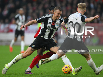 Dan Burn of Newcastle United is in action during the Premier League match between Nottingham Forest and Newcastle United at the City Ground...