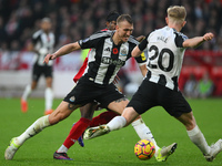 Dan Burn of Newcastle United is in action during the Premier League match between Nottingham Forest and Newcastle United at the City Ground...