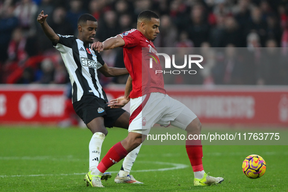 Murillo of Nottingham Forest shields the ball from Alexander Isak of Newcastle United during the Premier League match between Nottingham For...