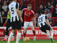 Elliott Anderson of Nottingham Forest is under pressure from Tino Livramento of Newcastle United during the Premier League match between Not...