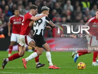 Ryan Yates of Nottingham Forest puts pressure on Bruno Guimaraes of Newcastle United during the Premier League match between Nottingham Fore...