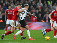 Ryan Yates of Nottingham Forest puts pressure on Bruno Guimaraes of Newcastle United during the Premier League match between Nottingham Fore...