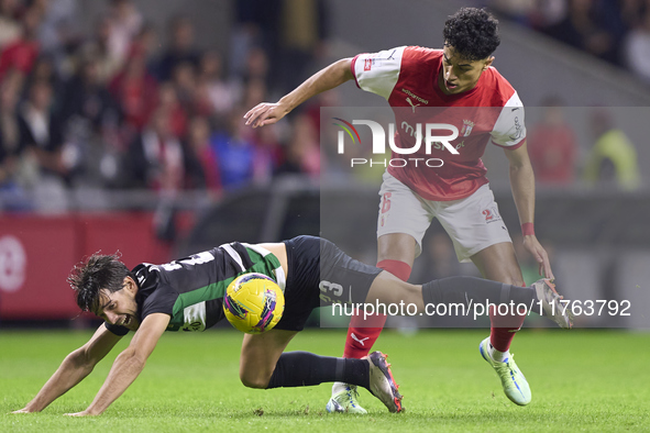 Vitor Carvalho of SC Braga competes for the ball with Daniel Braganca of Sporting CP during the Liga Portugal Betclic match between SC Braga...