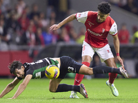 Vitor Carvalho of SC Braga competes for the ball with Daniel Braganca of Sporting CP during the Liga Portugal Betclic match between SC Braga...