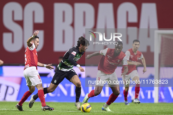 Joao Moutinho and Sikou Niakate of SC Braga compete for the ball with Francisco Trincao of Sporting CP during the Liga Portugal Betclic matc...