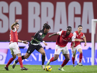 Joao Moutinho and Sikou Niakate of SC Braga compete for the ball with Francisco Trincao of Sporting CP during the Liga Portugal Betclic matc...