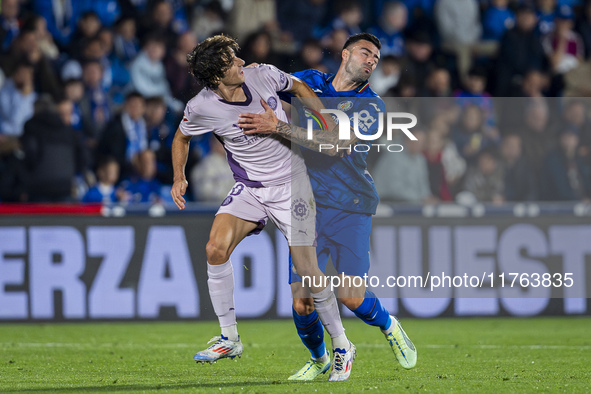 Bryan Gil of Girona FC (L) is in action against Diego Rico of Getafe CF (R) during the La Liga EA Sports 2024/25 football match between Geta...