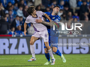 Bryan Gil of Girona FC (L) is in action against Diego Rico of Getafe CF (R) during the La Liga EA Sports 2024/25 football match between Geta...