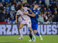 Bryan Gil of Girona FC (L) is in action against Diego Rico of Getafe CF (R) during the La Liga EA Sports 2024/25 football match between Geta...