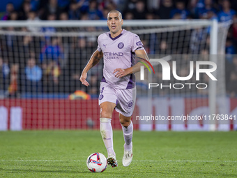 Oriol Romeu of Girona FC is in action with the ball during the La Liga EA Sports 2024/25 football match between Getafe CF and Girona FC at E...