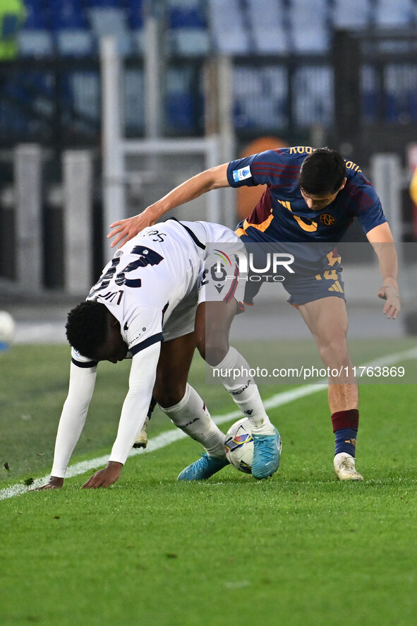 Jhon Lucumi of Bologna F.C. and Eldor Shomurodov of A.S. Roma are in action during the 12th day of the Serie A Championship between A.S. Rom...