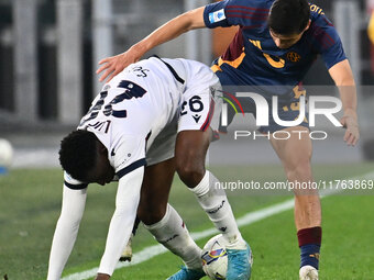 Jhon Lucumi of Bologna F.C. and Eldor Shomurodov of A.S. Roma are in action during the 12th day of the Serie A Championship between A.S. Rom...