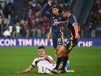 Thijs Dallinga of Bologna F.C., Leandro Paredes of A.S. Roma, and Bryan Cristante of A.S. Roma are in action during the 12th day of the Seri...