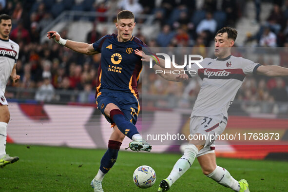 Artem Dovbyk of A.S. Roma and Sam Beukema of Bologna F.C. are in action during the 12th day of the Serie A Championship between A.S. Roma an...