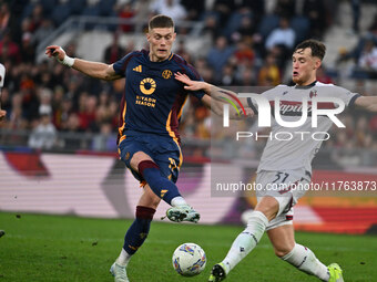 Artem Dovbyk of A.S. Roma and Sam Beukema of Bologna F.C. are in action during the 12th day of the Serie A Championship between A.S. Roma an...