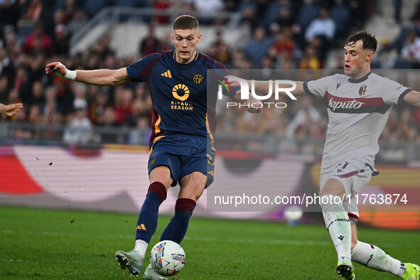 Artem Dovbyk of A.S. Roma and Sam Beukema of Bologna F.C. are in action during the 12th day of the Serie A Championship between A.S. Roma an...