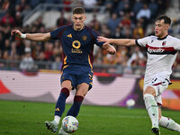 Artem Dovbyk of A.S. Roma and Sam Beukema of Bologna F.C. are in action during the 12th day of the Serie A Championship between A.S. Roma an...